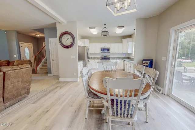 a kitchen with stainless steel appliances granite countertop a refrigerator and microwave