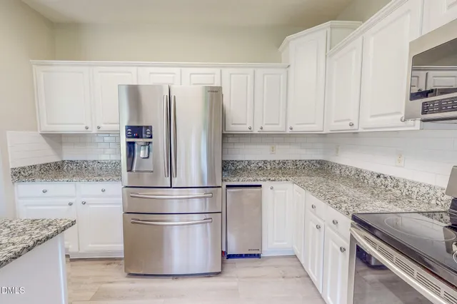 a kitchen with granite countertop a sink and a window