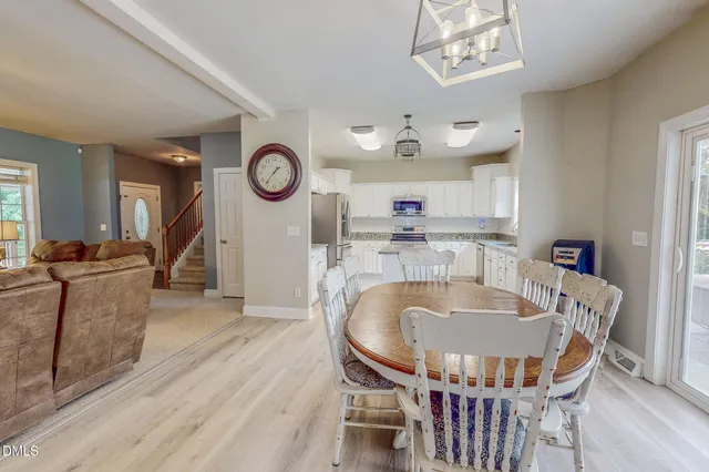 a view of a house with big yard and large trees