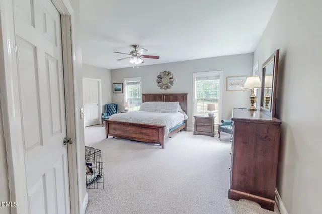 a spacious bedroom with a bed and a chandelier