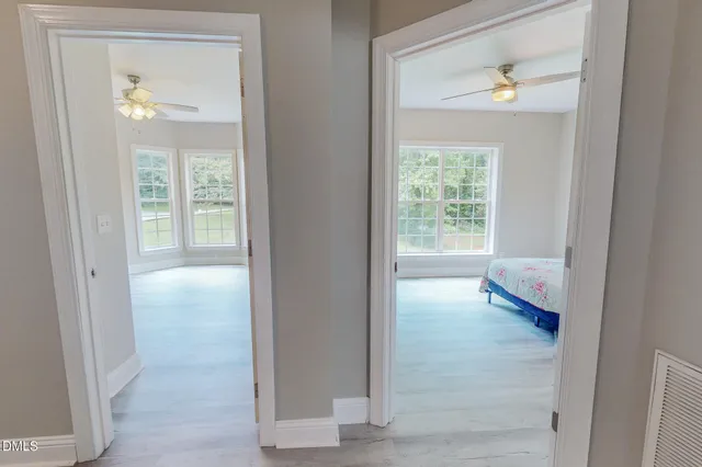 a bathroom with a granite countertop toilet and a glass door