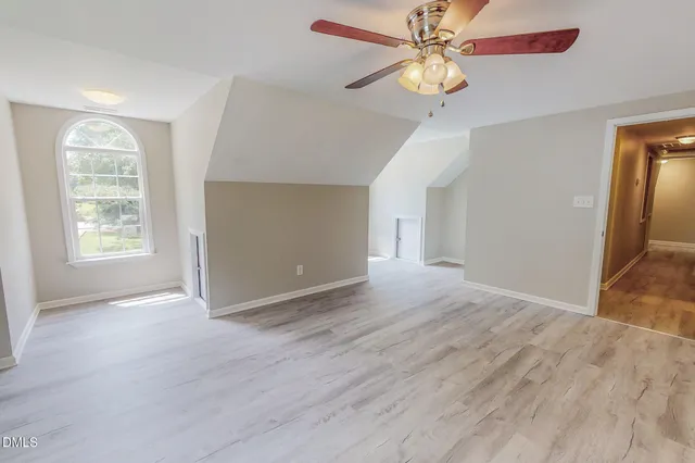 wooden floor in a hall with an entryway and a livingroom