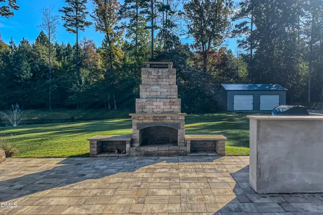 a front view of a house with a garden and yard