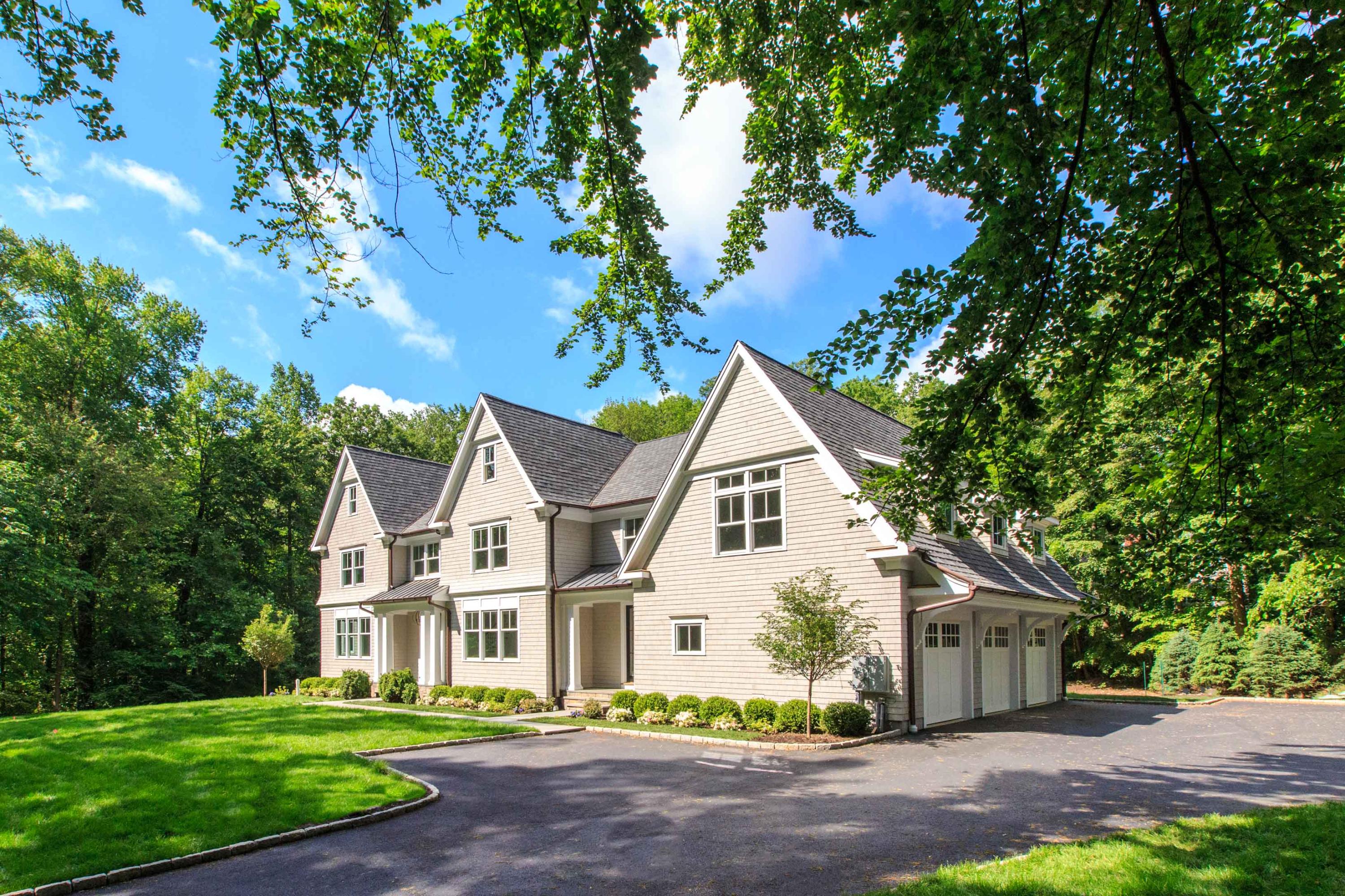 72 Deepwood Road Darien, CT 06820 - Photo 2 of 39 a view of a white house next to a yard with big trees