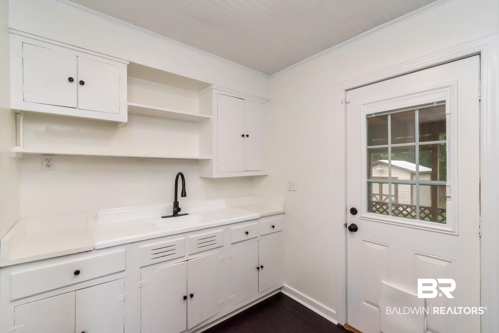 208 Morgan Avenue Mobile, AL 36606 - Photo 14 of 27 Kitchen featuring ornamental molding, sink, and white cabinets
