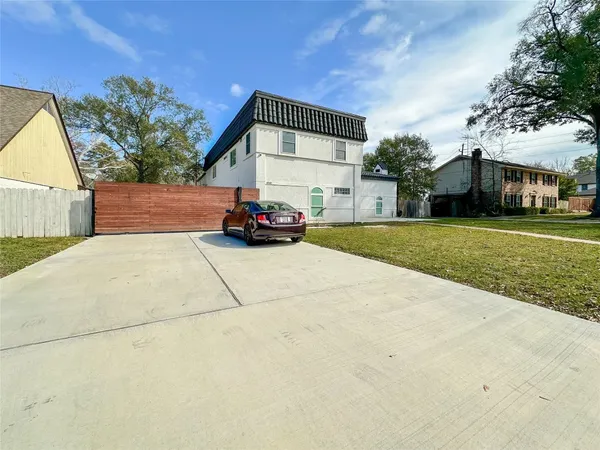 a view of a house with a yard and garage