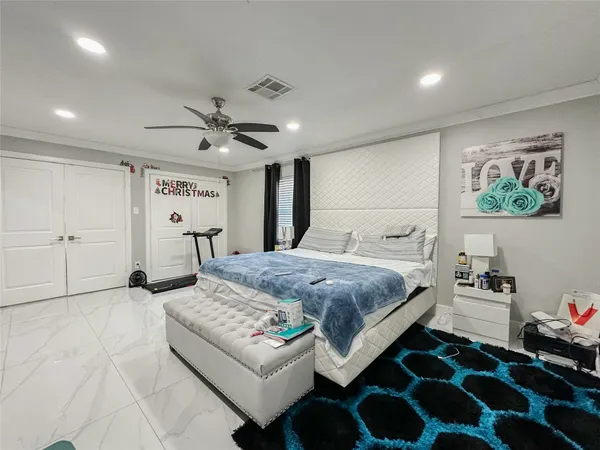 a bedroom with a bed and a large window