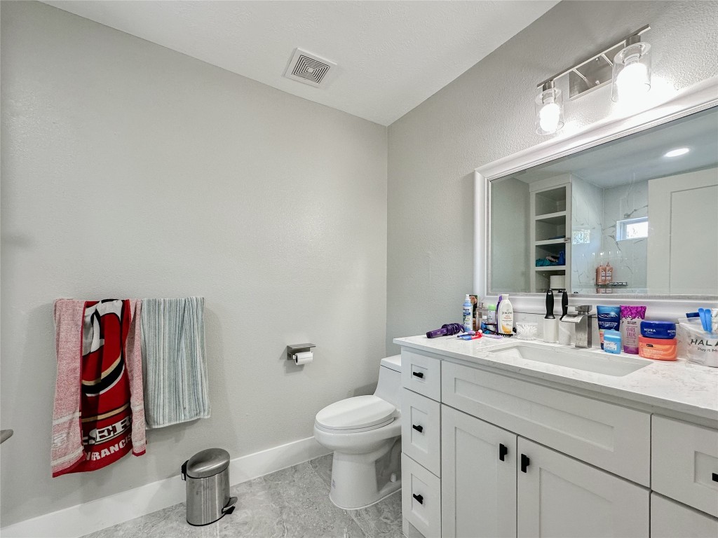 19310 Enchanted Oaks Drive Spring, TX 77388 - Photo 26 of 49 a bathroom with a sink mirror vanity and toilet