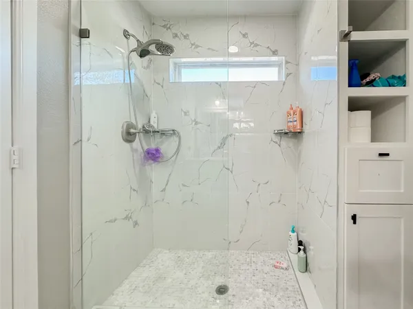 a spacious bedroom with a bed a couch and dresser