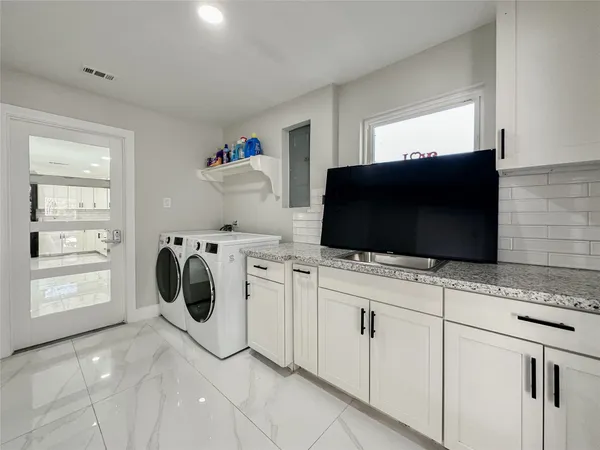 a living room with furniture and kitchen view