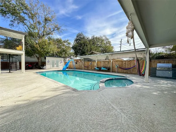 a view of backyard with swimming pool
