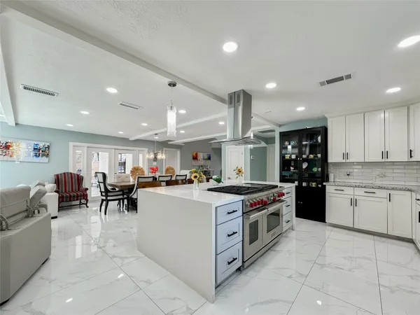 a kitchen with stainless steel appliances a stove a sink and a refrigerator