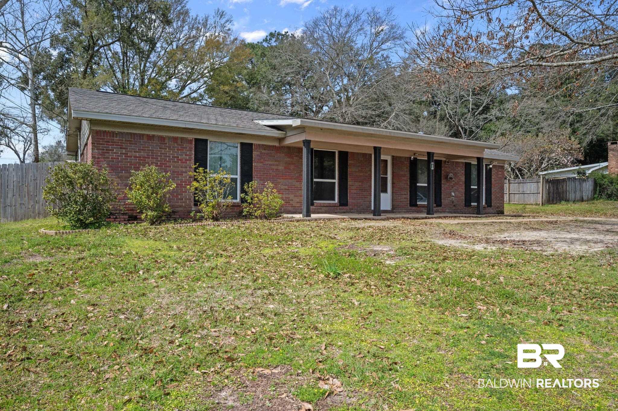 122 Rita Avenue Spanish Fort, AL 36527 - Photo 3 of 17 Ranch-style house with brick siding, a front yard, and fence