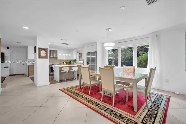 a living room with furniture and kitchen view