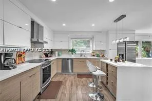 a kitchen with a sink stove cabinets and refrigerator