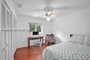 a bedroom with a bed a desk and chair