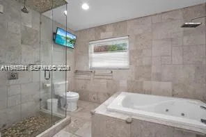 a bathroom with a bathtub a toilet and a shower