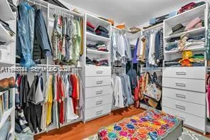 a view of walk in closet with clothes