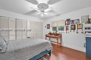 a bedroom with furniture and a wooden floor