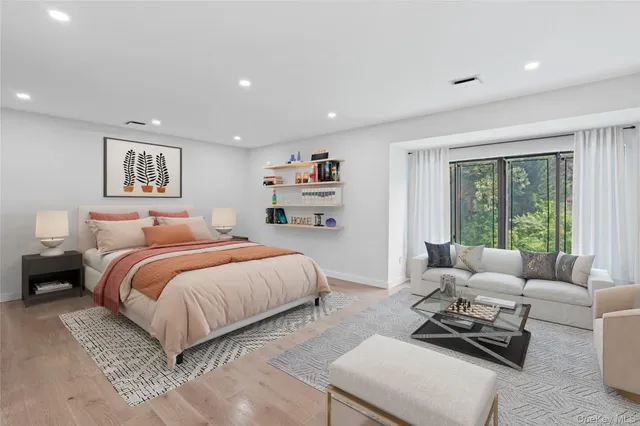 a spacious bedroom with a bed and glass window