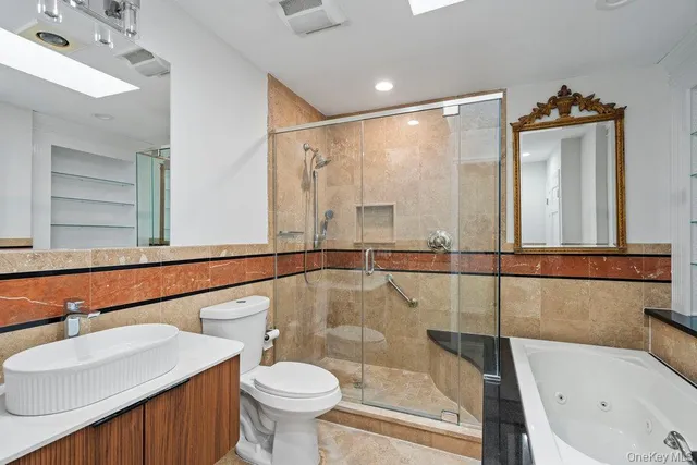 a bathroom with a sink mirror toilet and bathtub