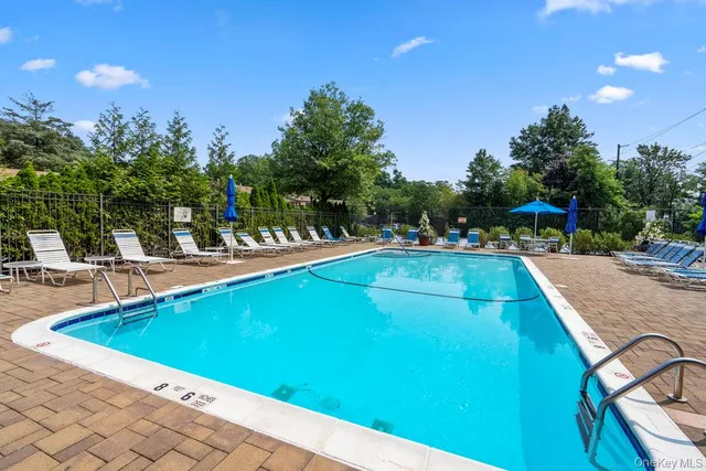a view of a swimming pool with an outdoor seating