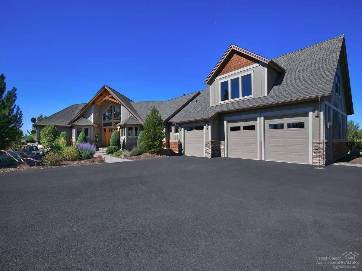 20200 Marsh Road Bend, OR 97703 - Photo 3 of 25 a front view of a house with a yard and garage
