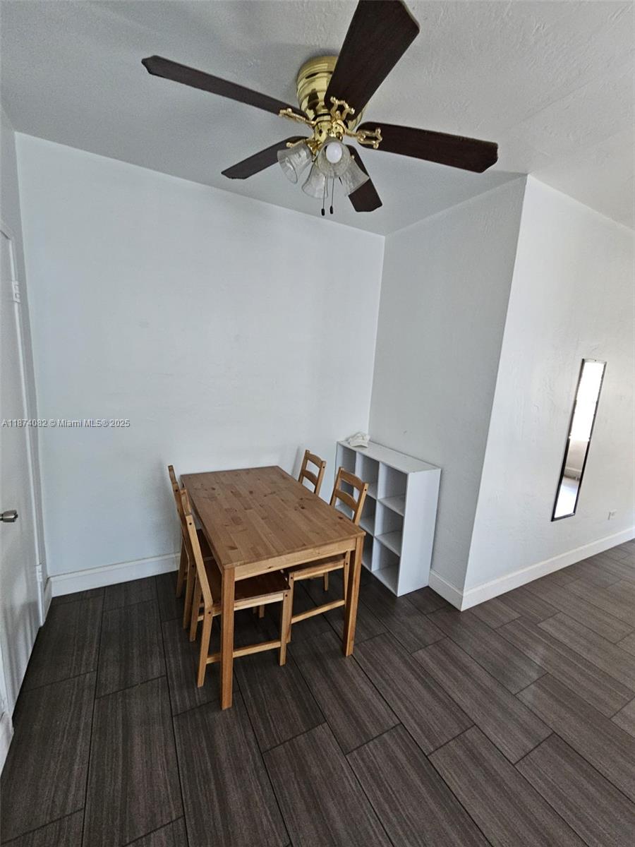 7320 Carlyle Avenue, Unit 4 Miami Beach, FL 33141 - Photo 5 of 8 a room with wooden floor and staircase