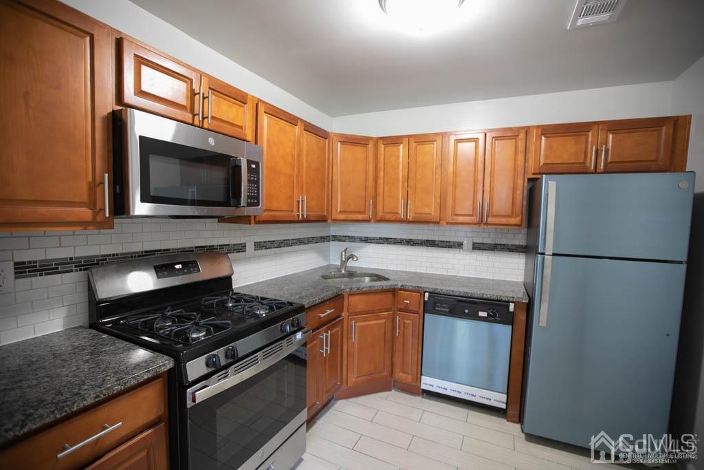 3301 Hana Road Edison, NJ 08817 - Photo 31 of 39 a kitchen with a refrigerator stove and microwave