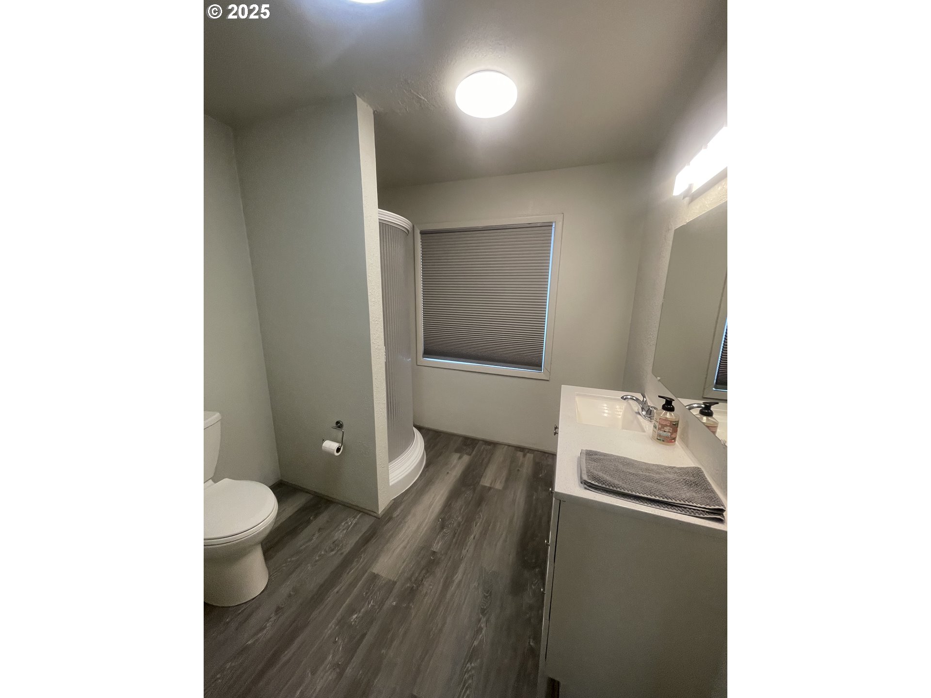 62886 Highway 74 Ione, OR 97843 - Photo 11 of 15 a bathroom with a sink and mirror with toilet