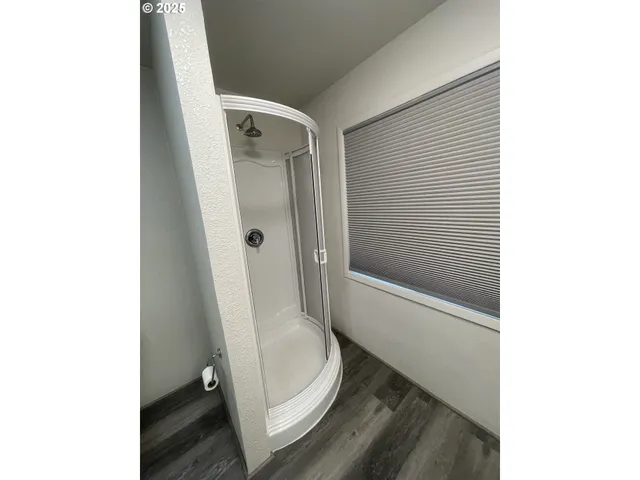 a bathroom with a toilet and a shower