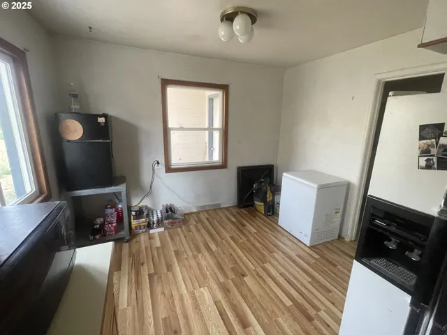 a bedroom with a bed and a flat tv screen on a dresser
