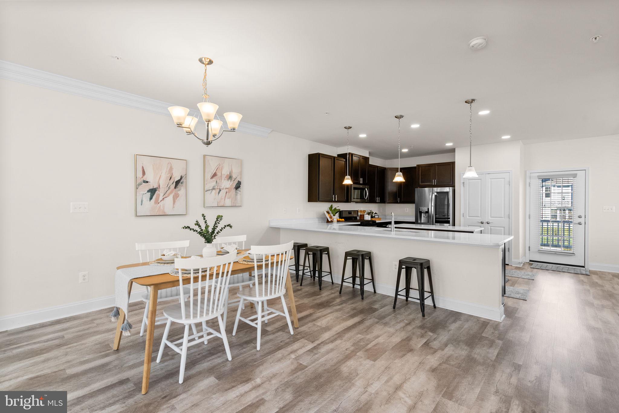 2 Hanover Road Reisterstown, MD 21136 - Photo 6 of 30 a view of a dining room with furniture wooden floor and kitchen view