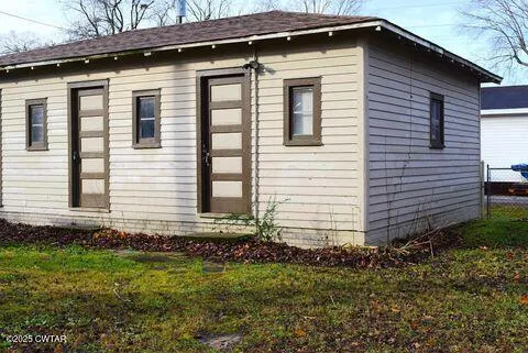 a small white house with a white roof