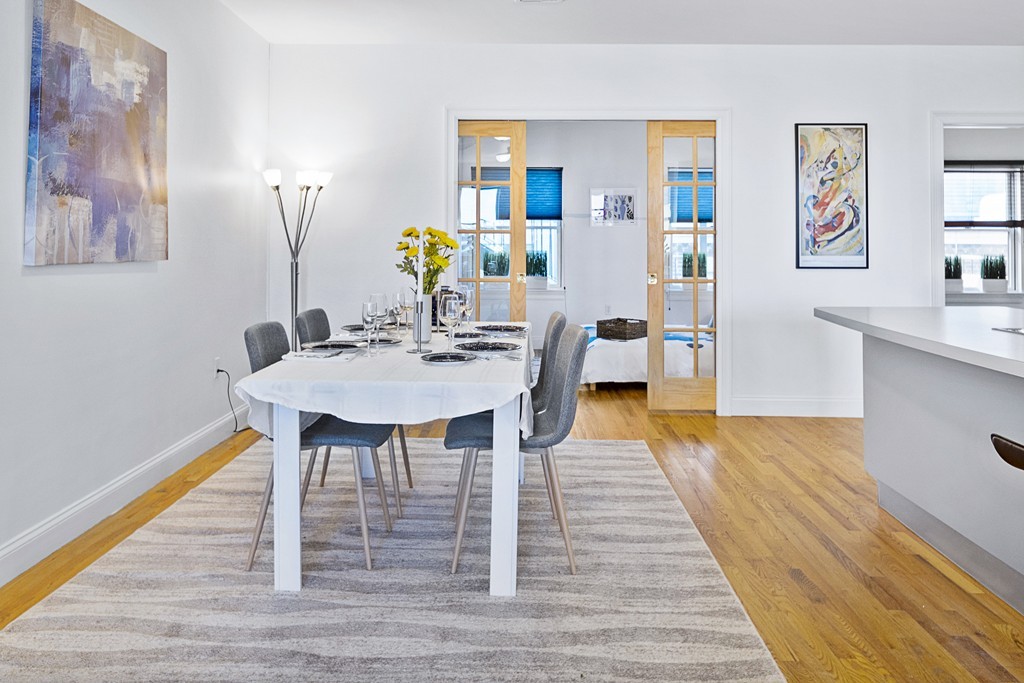 877 Harrison Avenue, Unit 7 Boston, MA 02118 - Photo 11 of 25 a view of a dining room with furniture and wooden floor