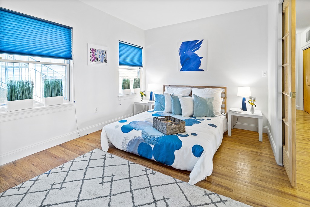 877 Harrison Avenue, Unit 7 Boston, MA 02118 - Photo 16 of 25 a living room with a bed and a large window