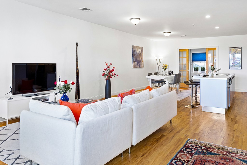 877 Harrison Avenue, Unit 7 Boston, MA 02118 - Photo 4 of 25 a living room with furniture and a flat screen tv