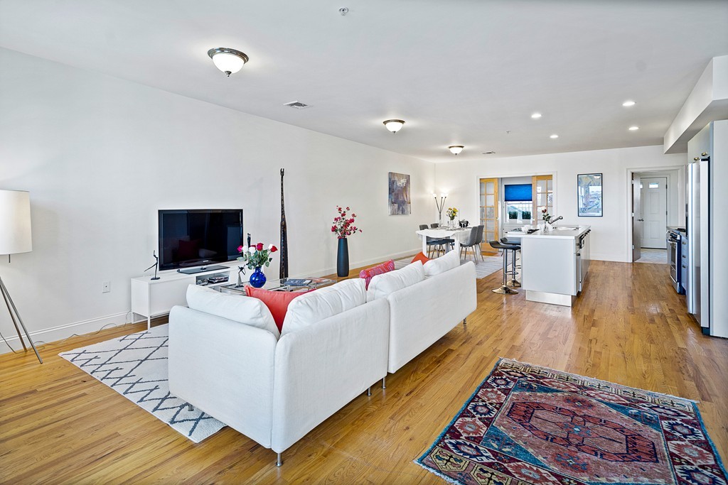 877 Harrison Avenue, Unit 7 Boston, MA 02118 - Photo 5 of 25 a living room with furniture and a flat screen tv