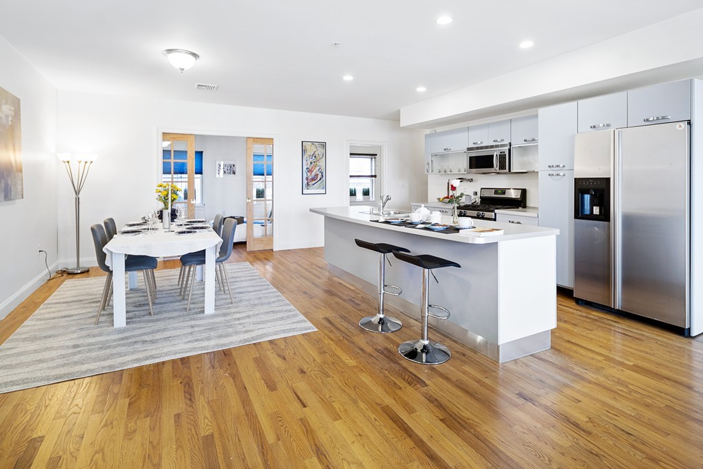 877 Harrison Avenue, Unit 7 Boston, MA 02118 - Photo 9 of 25 a living room with stainless steel appliances furniture stove and kitchen view