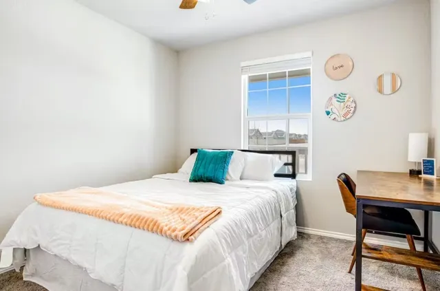 a bedroom with a bed and a table in it