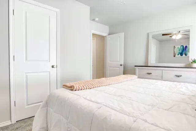 a bedroom with a bed and a mirror