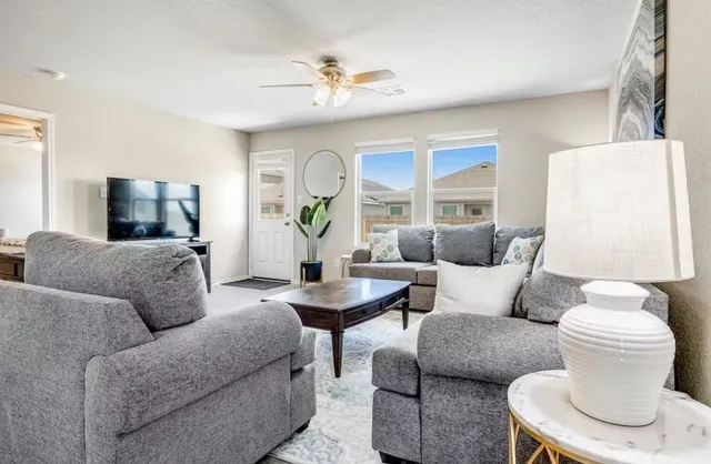 a living room with furniture and a large window