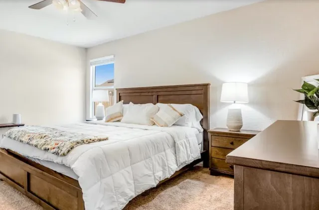 a bedroom with a bed and a lamp