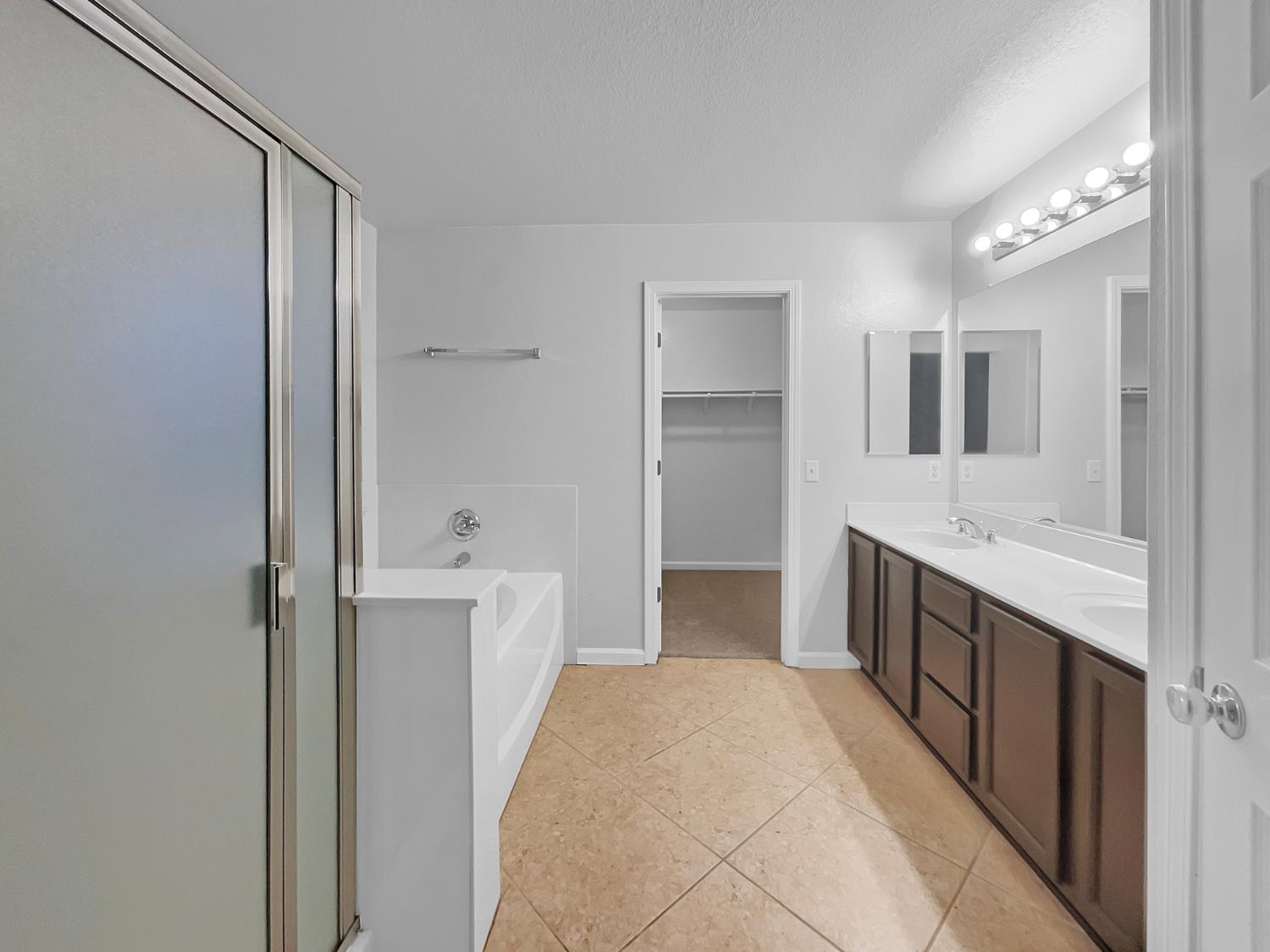 6130 Preston Circle Rocklin, CA 95765 - Photo 14 of 24 a spacious bathroom with a bathtub sink and mirror