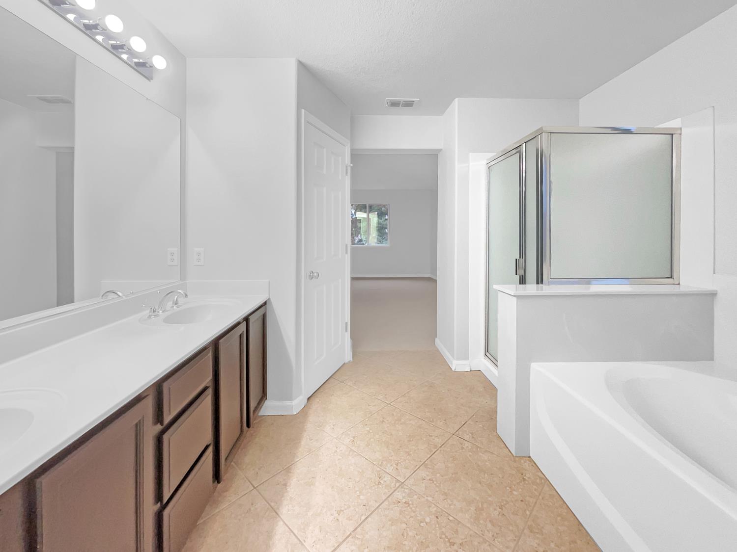 6130 Preston Circle Rocklin, CA 95765 - Photo 15 of 24 a bathroom with a tub sink and mirror