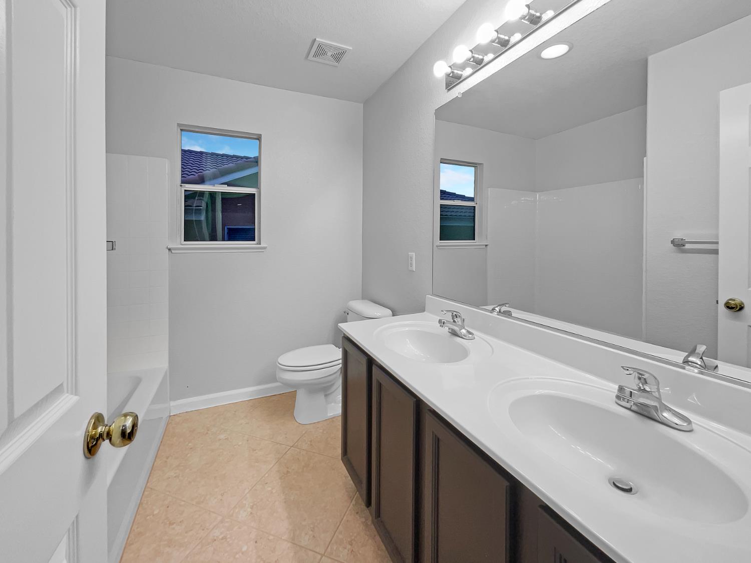 6130 Preston Circle Rocklin, CA 95765 - Photo 16 of 24 a bathroom with a double vanity sink a toilet and a mirror