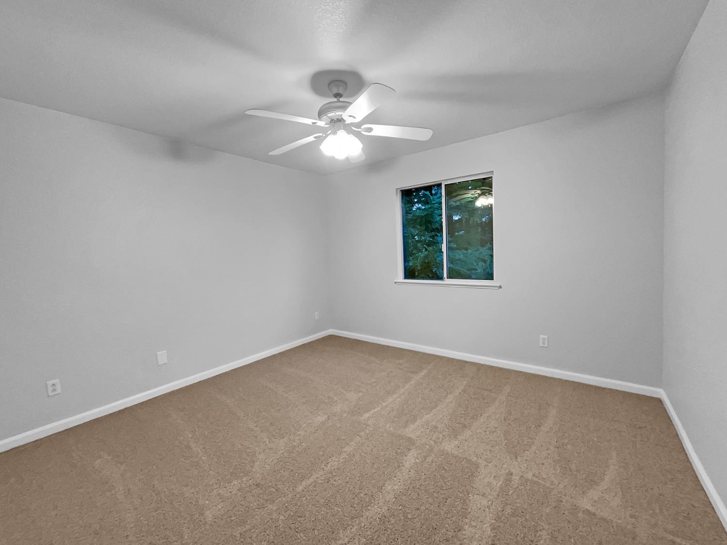 6130 Preston Circle Rocklin, CA 95765 - Photo 18 of 24 an empty room with a window and a fan
