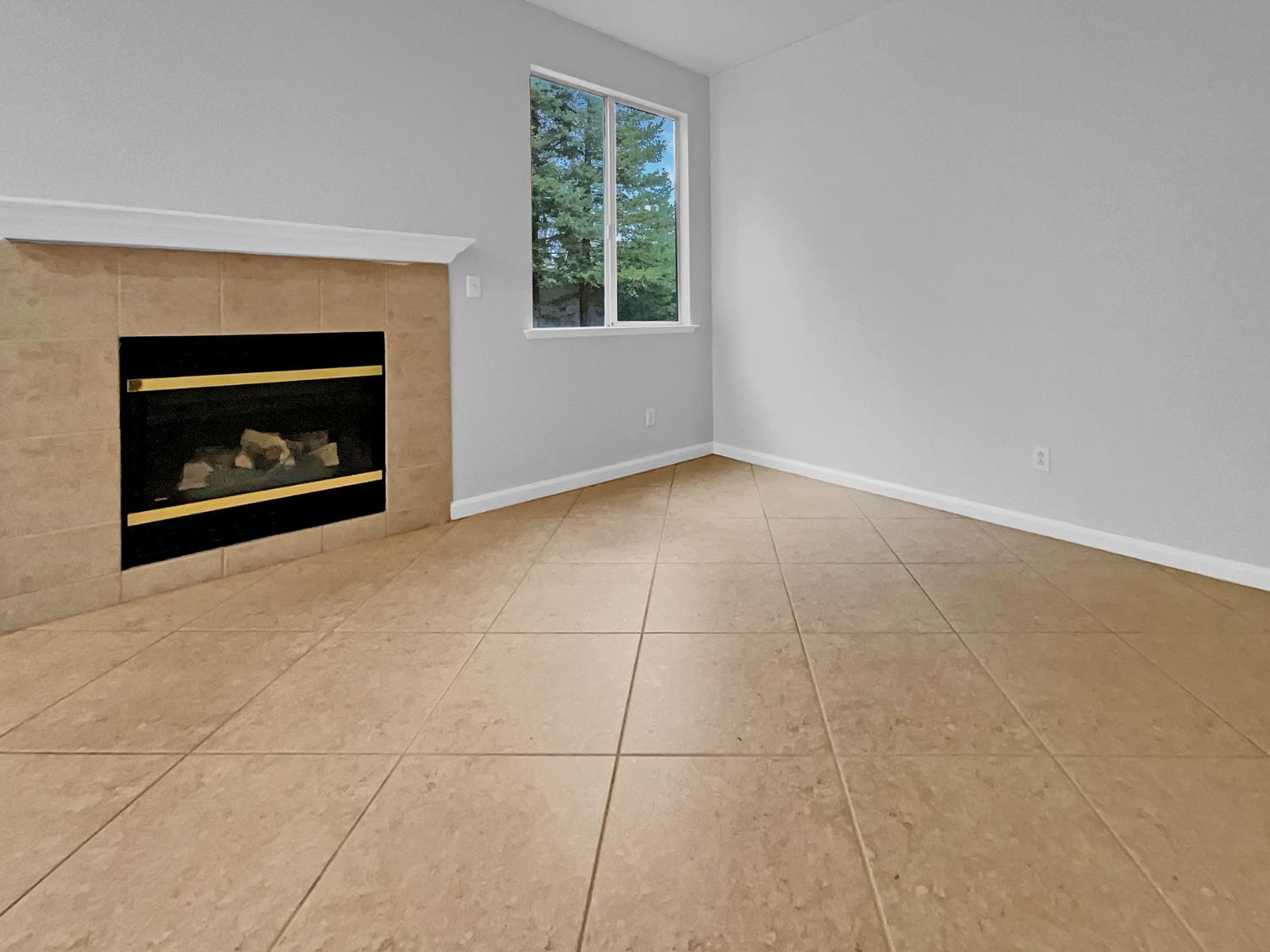 6130 Preston Circle Rocklin, CA 95765 - Photo 6 of 24 a view of an empty room with a fireplace and a window