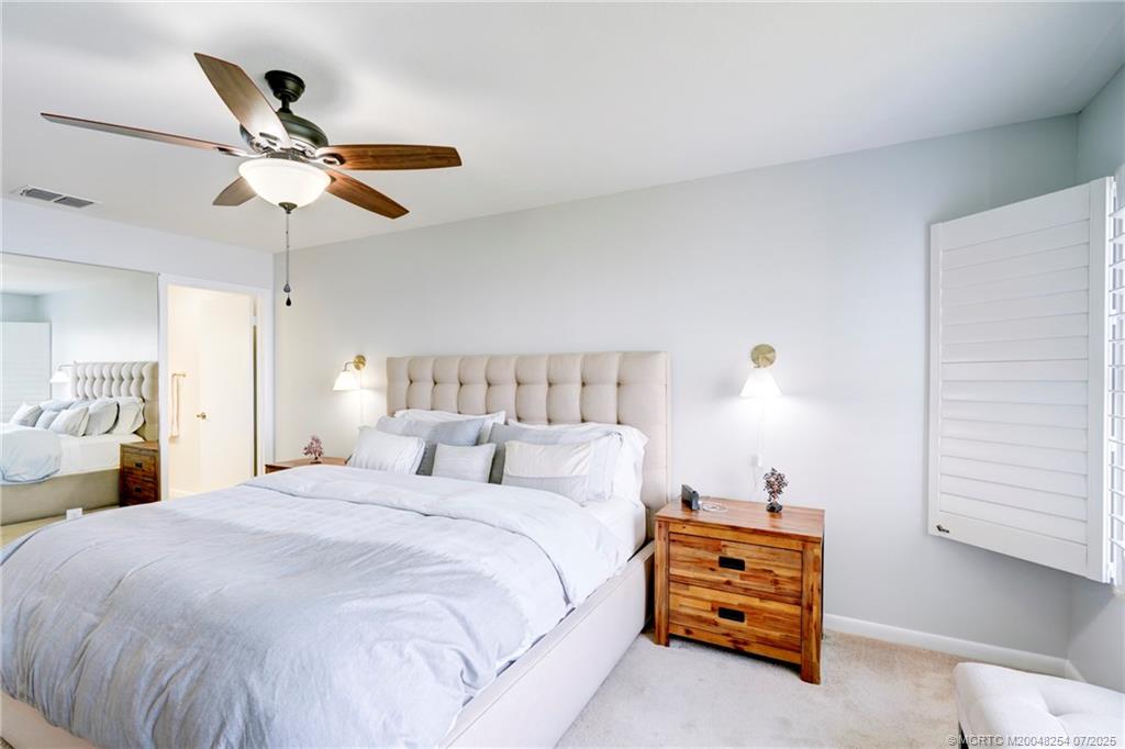 20 Northeast Plantation Road, Unit 307 Stuart, FL 34996 - Photo 36 of 52 a bedroom with a bed and window