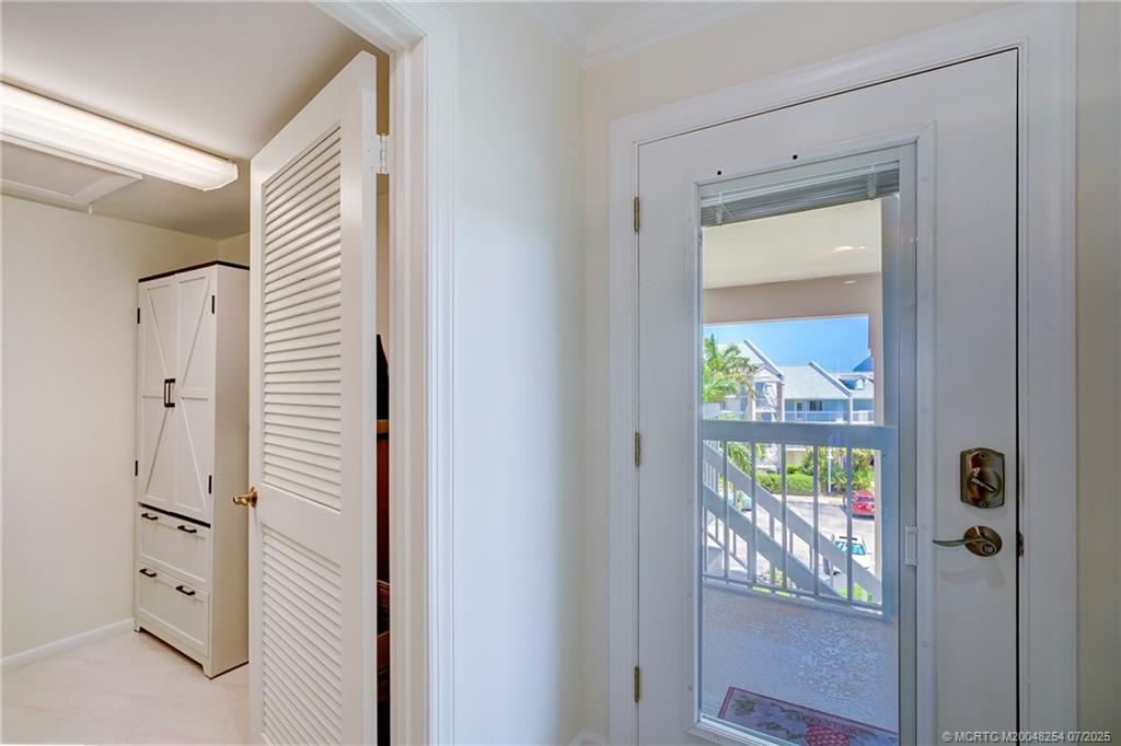 20 Northeast Plantation Road, Unit 307 Stuart, FL 34996 - Photo 8 of 52 a view of an entryway with wooden floor